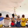 people holding shoulders sitting on wall